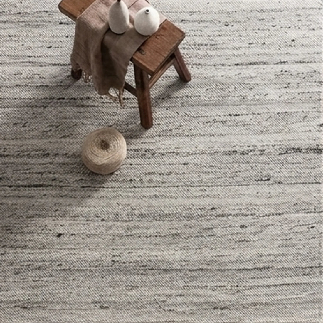 Natural Wool Carpet — scale reference beside a complementary prop