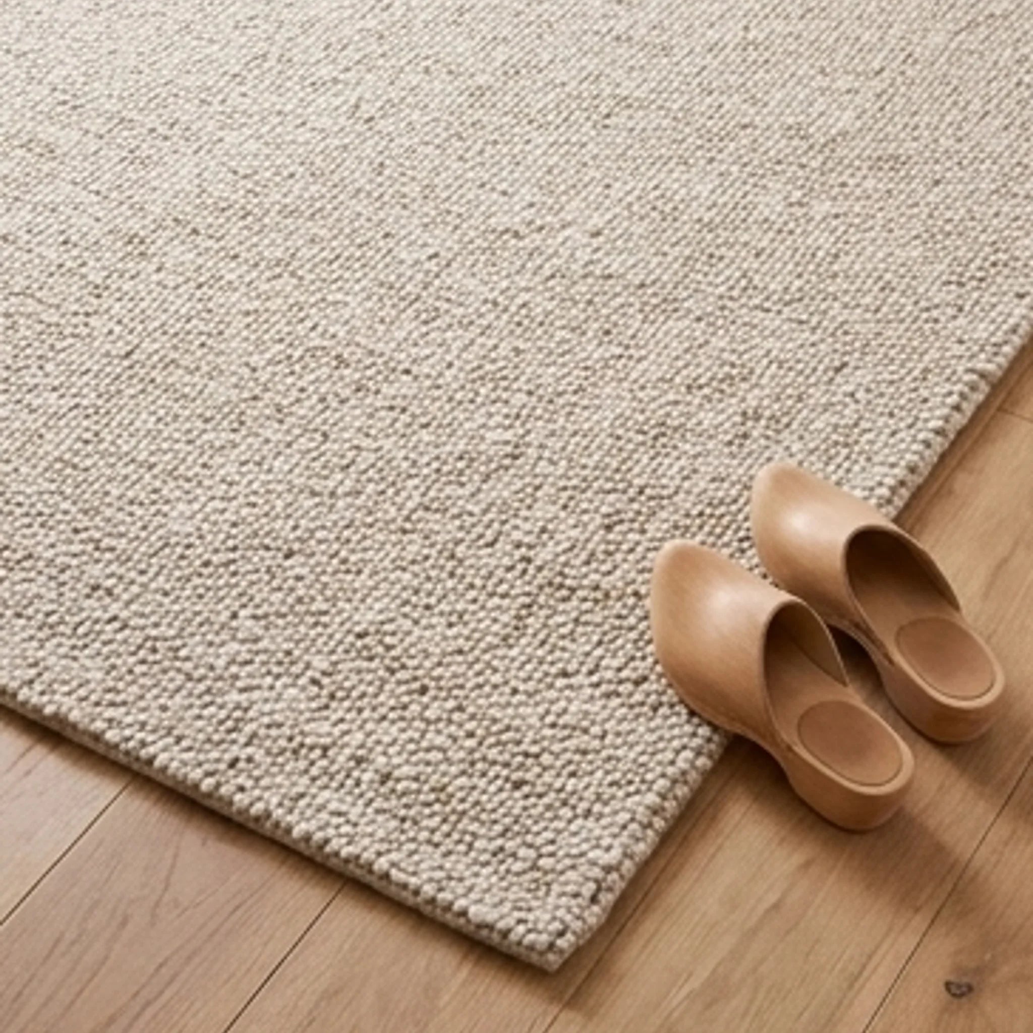 Natural Handwoven New Zealand Wool Rug — scale reference beside a complementary prop