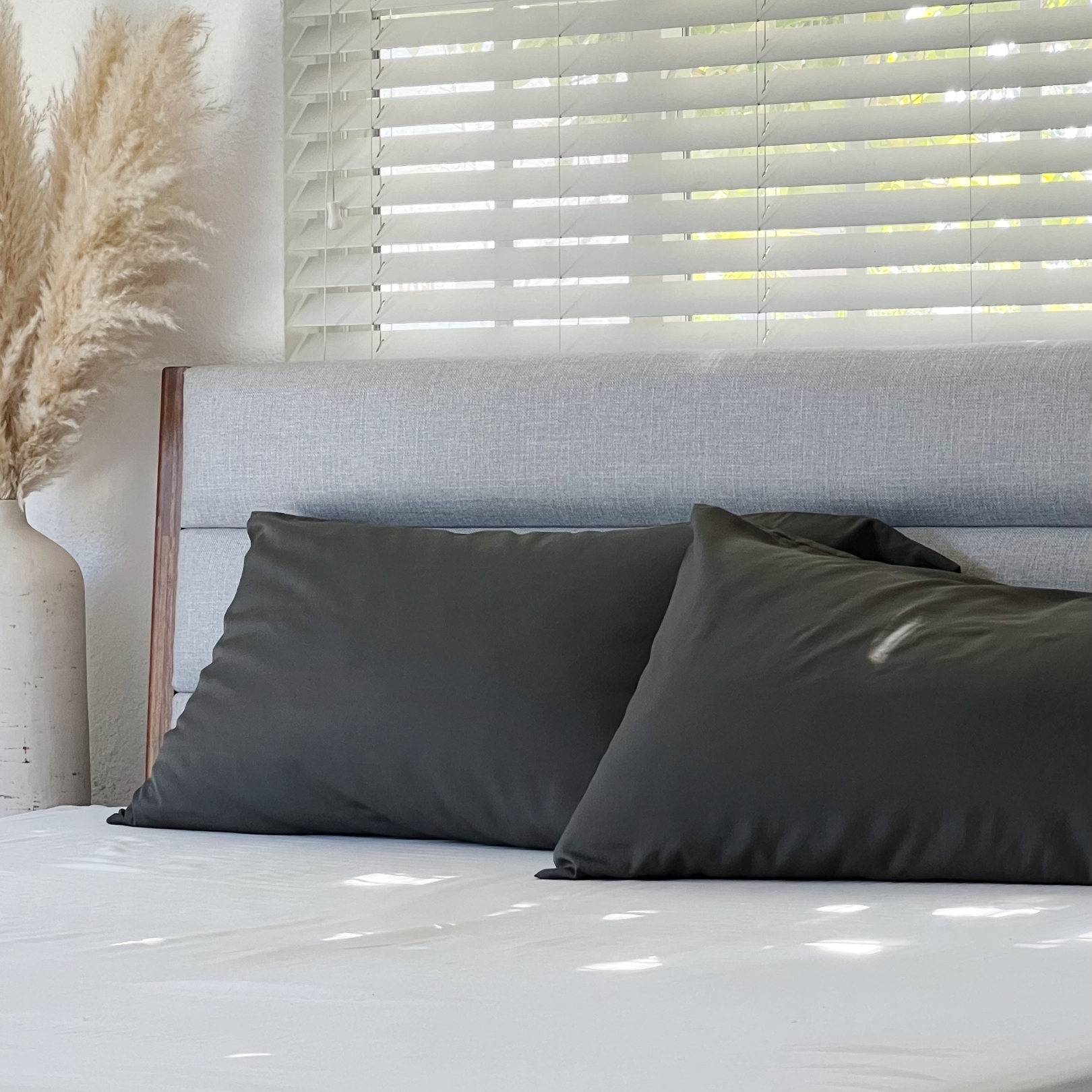 Charcoal Copper Infused Bamboo Pillowcase Set on a bed with natural light.