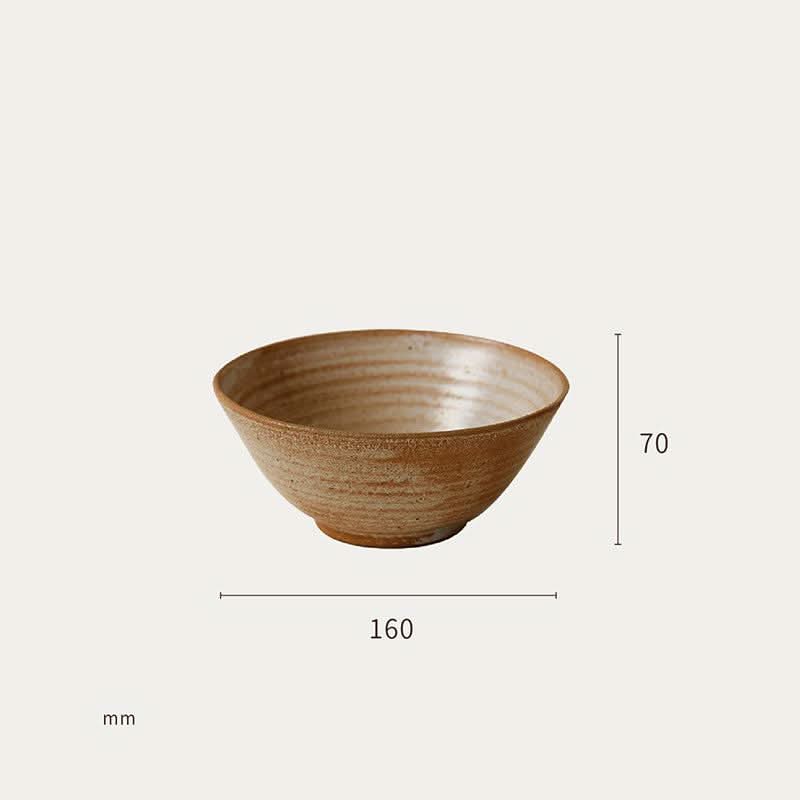 Brown clay bowl, part of a handmade tableware set, with rustic texture and earthy tones.