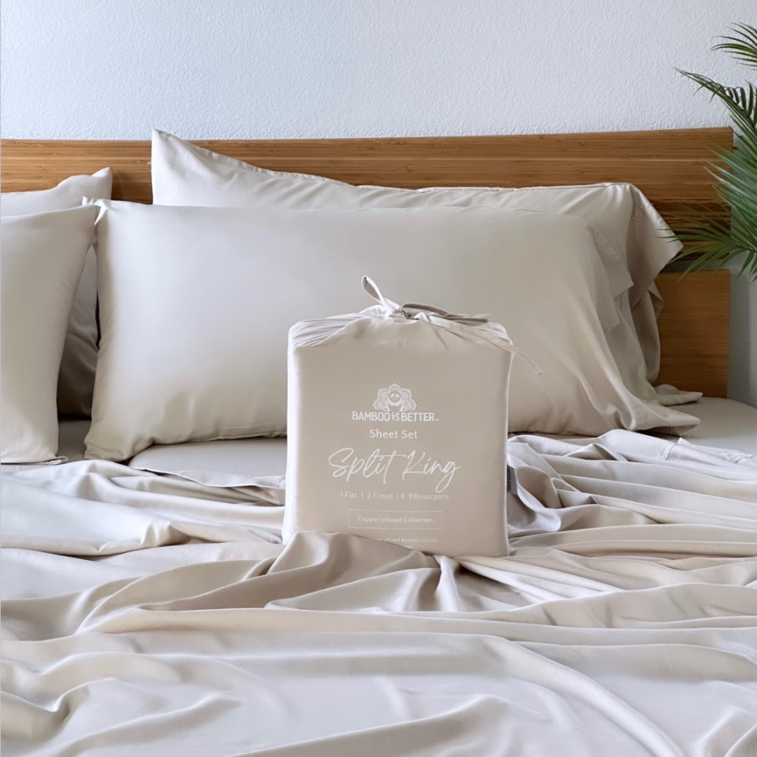 Light beige copper infused bamboo pillowcase set folded with a bamboo headboard and pillows.