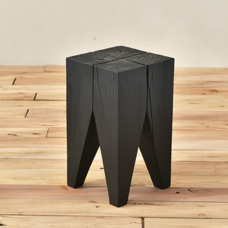 Black wooden stool, unique design, rustic style.