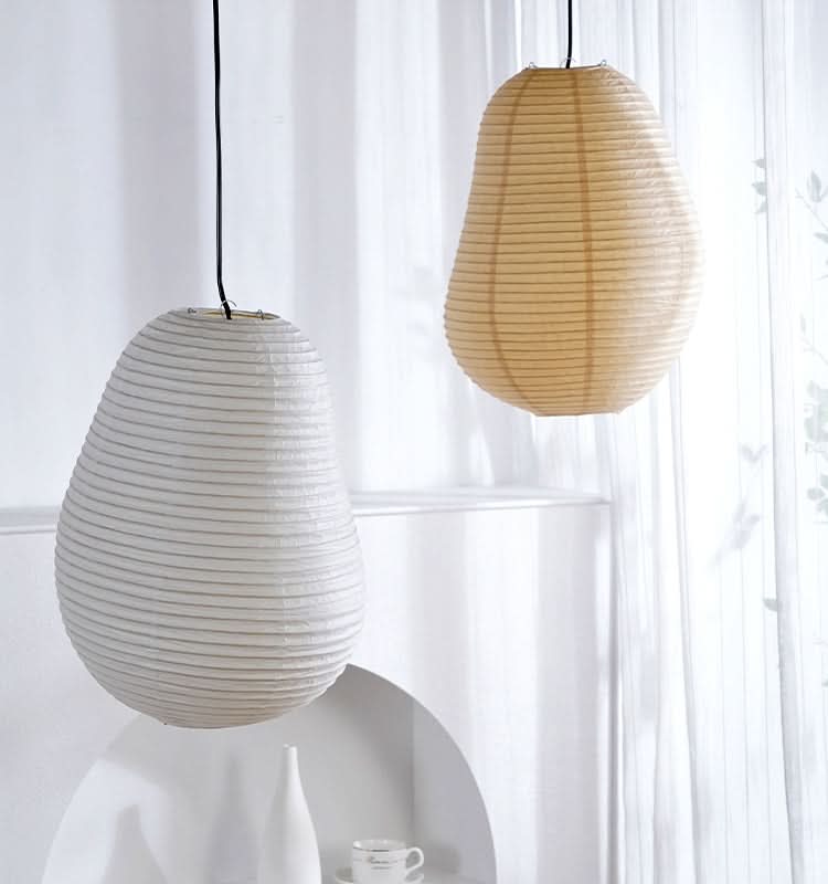 White and beige irregular shape paper lampshades hanging indoors, home decor lighting.