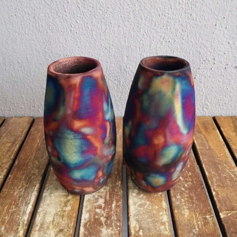 Two raku pottery vases, vibrant multicolored with copper tones, perfect for home decor.