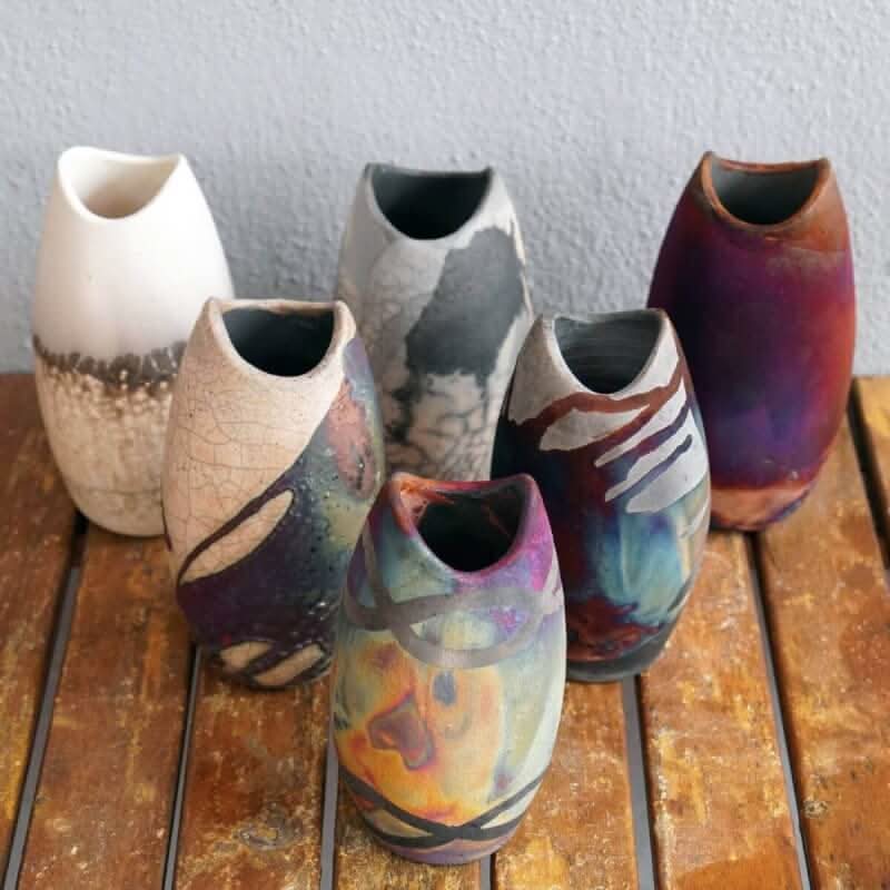 Two handmade ceramic koi vases, various colors, decorative.