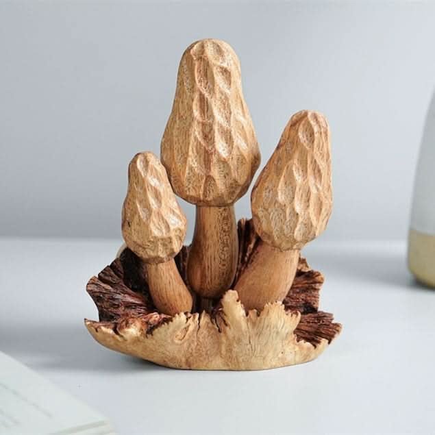 Hand-carved wooden mushroom sculpture with intricate detail, natural wood tones, set on textured bark base.