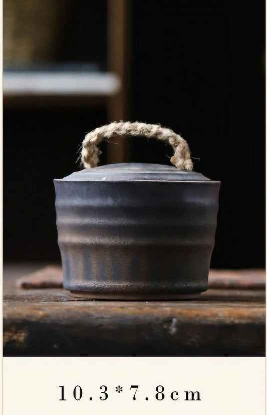  Wabi-Sabi Bucket Ceramic Jar with a rope handle, placed on a wooden table for display