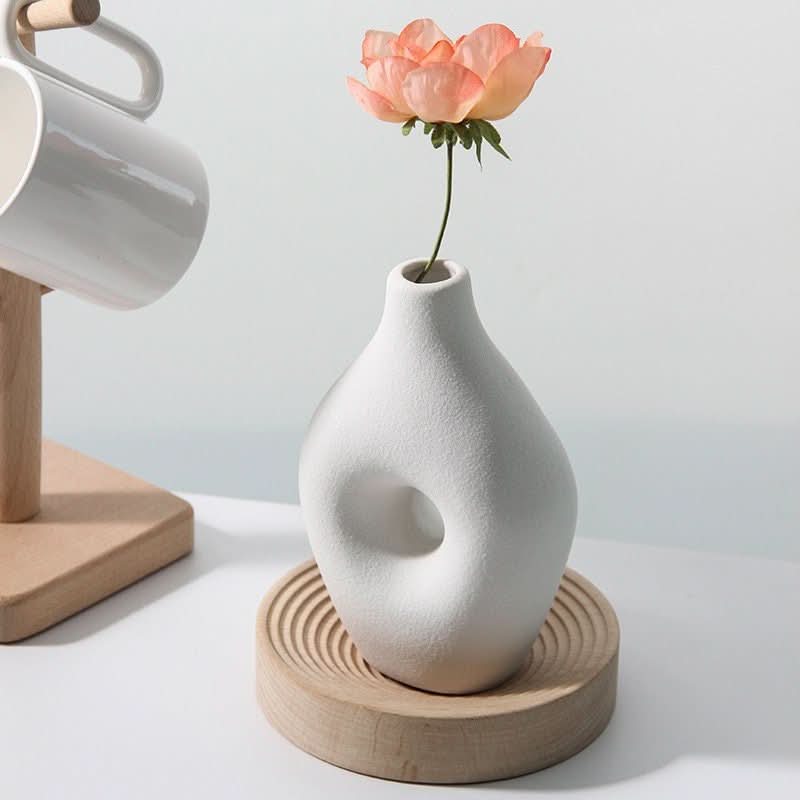 2x1 Nordic hollow vase in white ceramic with peach flower on wooden coaster.