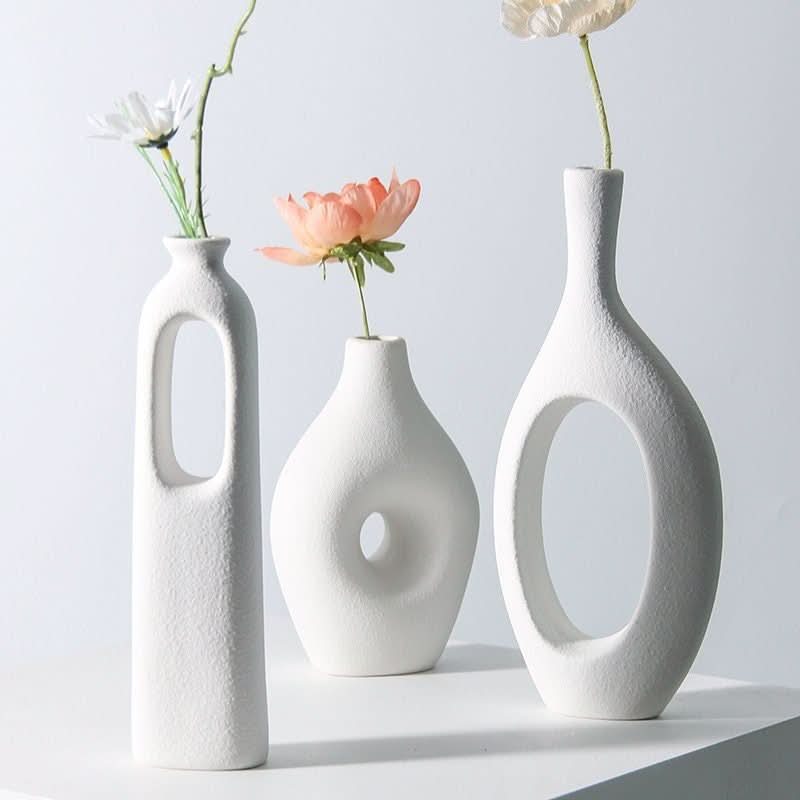 White Nordic hollow vases for dried flowers, unique minimalist home decor pieces.