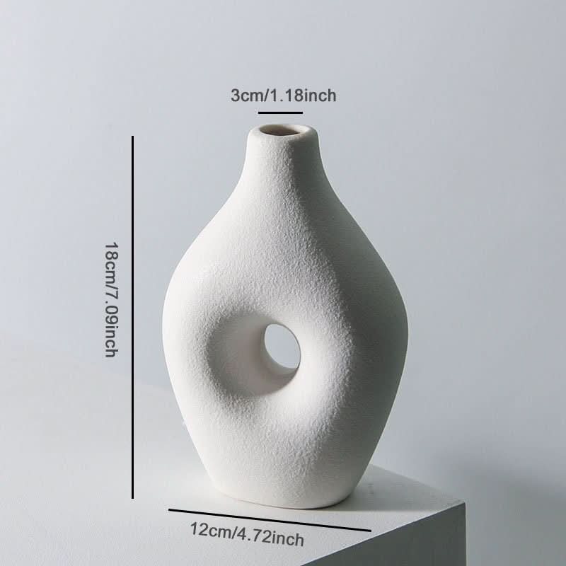 White Nordic hollow vase for dried flowers, a minimalist ceramic home decor piece.