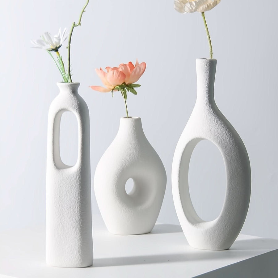 White Nordic hollow vases with dried flowers, ideal for home decor