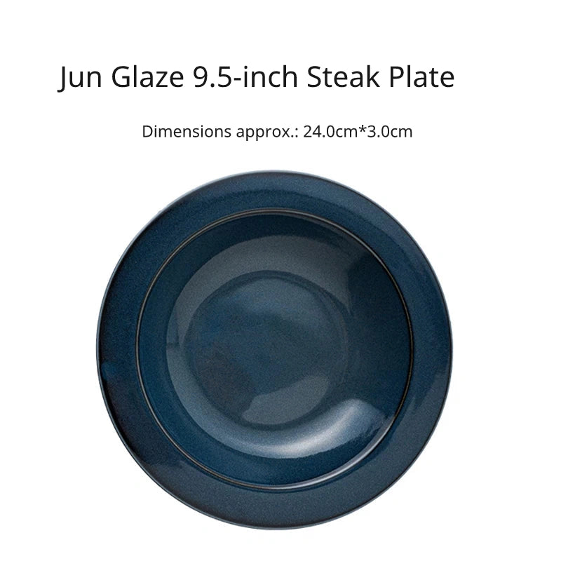Overhead view of a large 9.5 inch round dark blue ceramic steak or dinner plate with a wide rim.