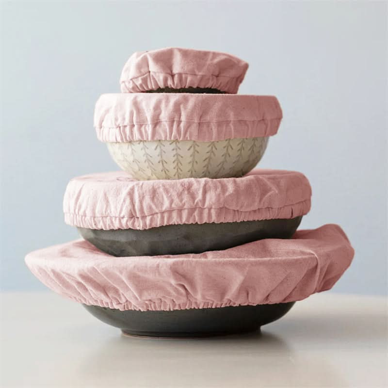 Stack of 4 pink linen bowl covers protecting bowls.