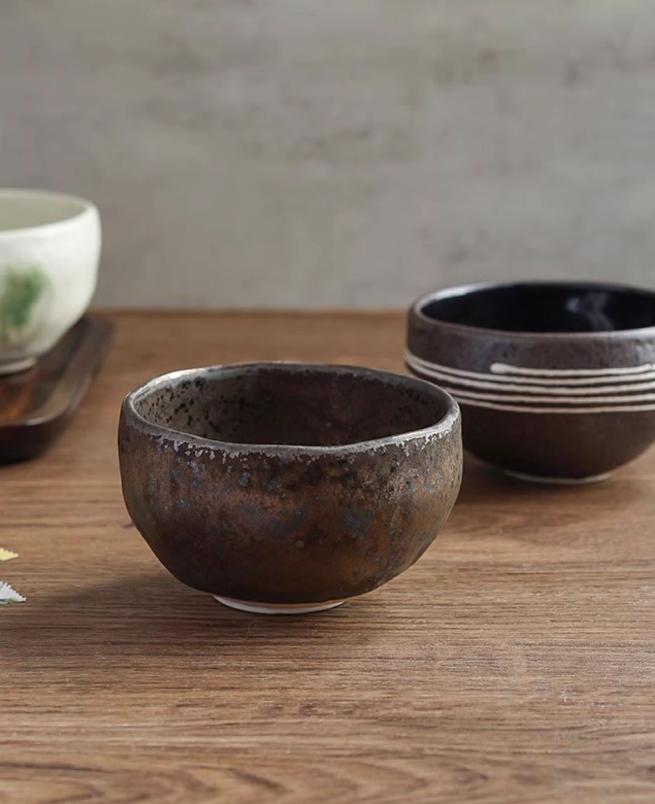 Japanese imported Mino-yaki wedge-shaped matcha bowl, rustic brown ceramic with speckled texture.