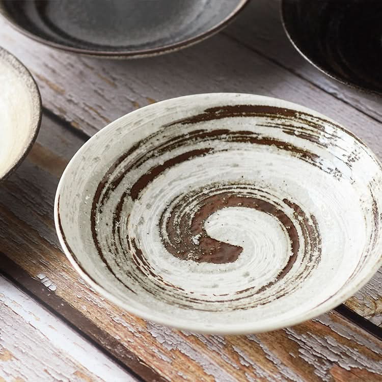 White & brown Japanese Pottery Tableware 9" with spiral design on rustic wood table