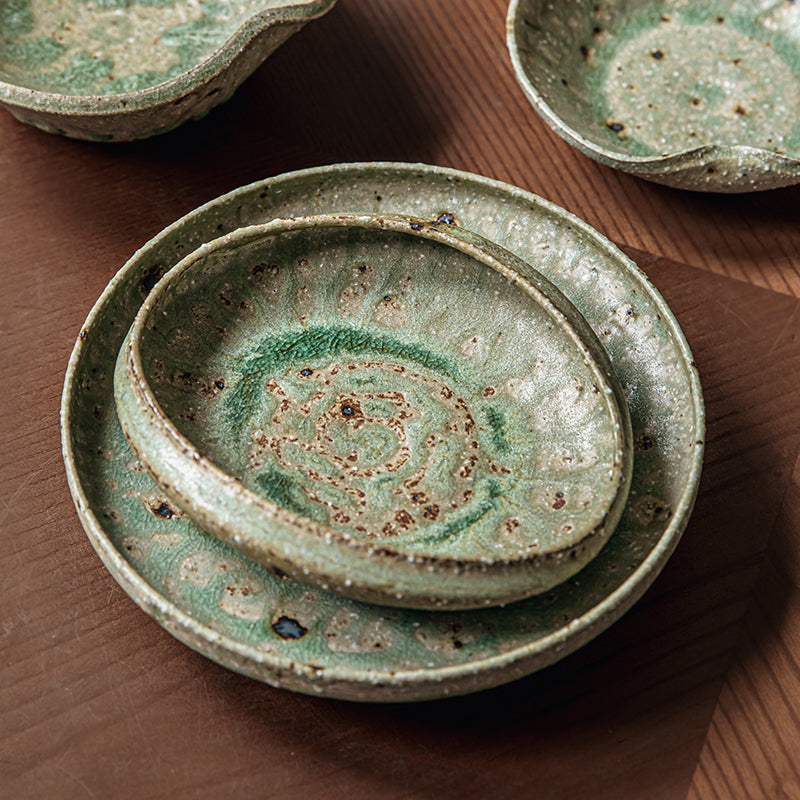 Handcrafted green & brown ceramic dinnerware set; unique reactive glaze; rustic, artisanal style.