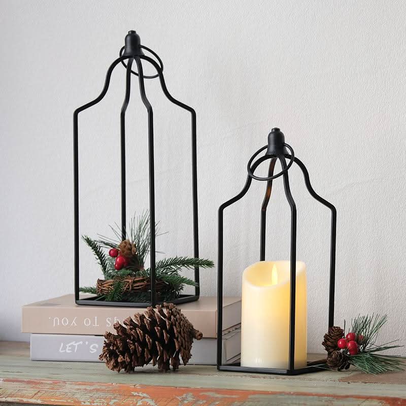 Black metal line candle holder set of 2 with pinecones & berries decor.