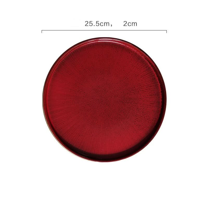 Deep red flat ceramic glazed plate, kiln glazed tableware with textured surface. 25.5cm diameter.