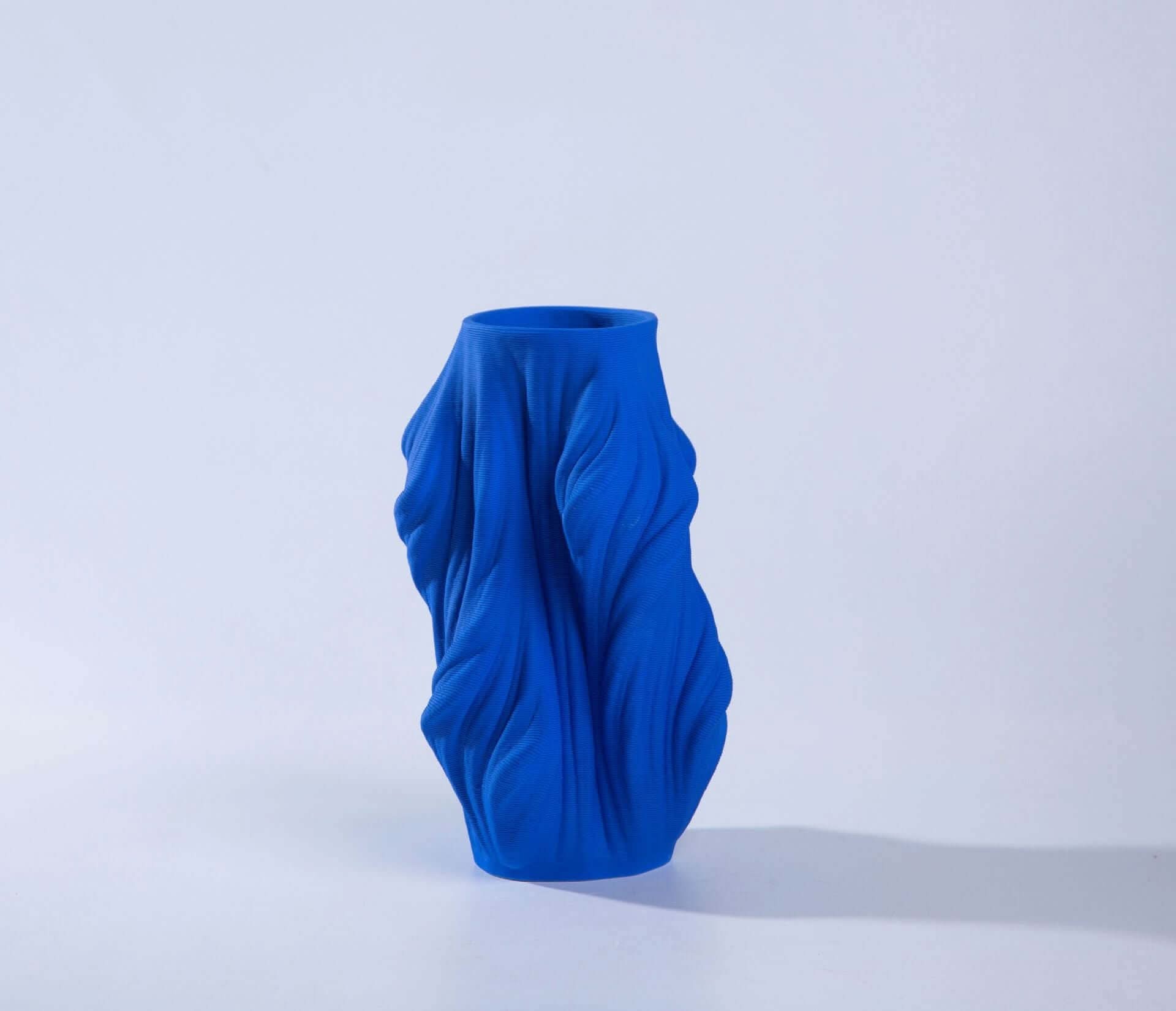 Vibrant blue 3D printed ceramic vase with draped fabric texture, home decor