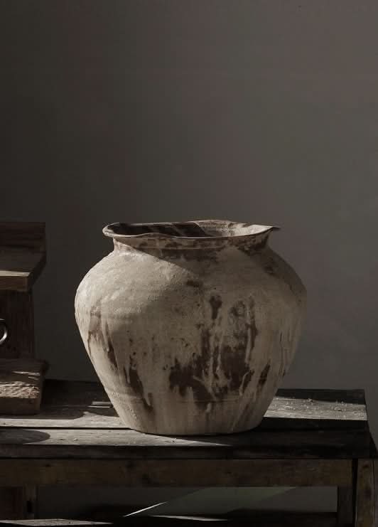 Rustic, handmade ceramic vase in beige and brown, textured with drip glaze. Home decor.