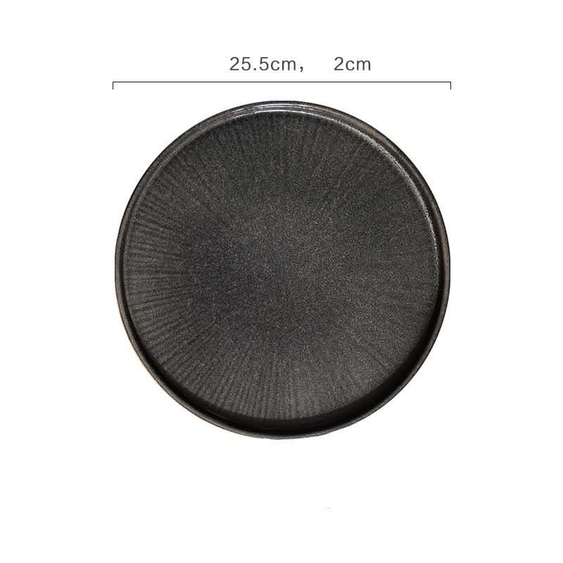 Flat ceramic glazed plate in charcoal with textured surface, part of kiln glazed tableware.