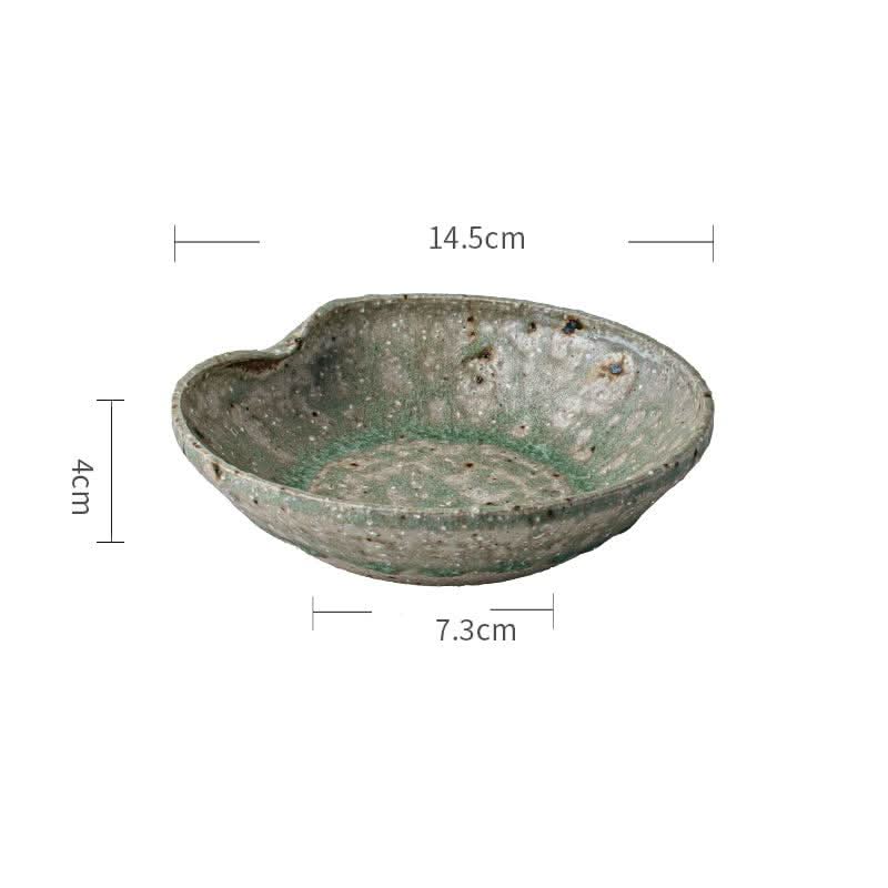 Artisan Green Dinnerware: Rustic ceramic bowl with mottled green and grey glaze.
