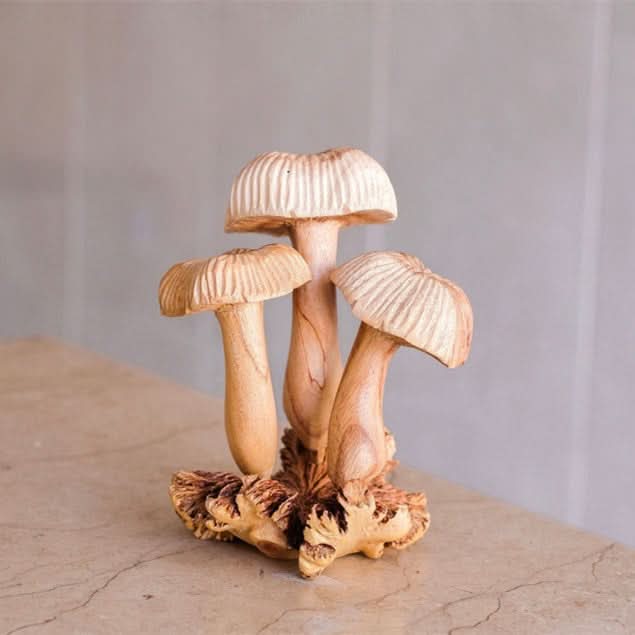 Light brown, hand-carved wood mushroom sculpture for home decor.