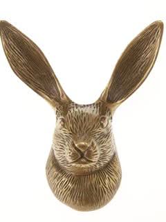 Antique brass hare wall hook, detailed and textured for home decor.