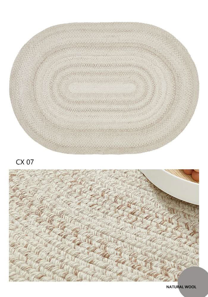 Oval braided wool rug in natural beige and brown hues, showcasing a cozy texture.