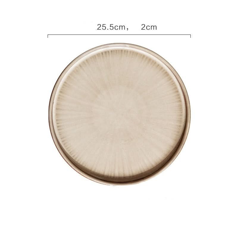 Flat ceramic glazed plate with a subtle sunburst pattern in a neutral tone. Kiln glazed tableware.