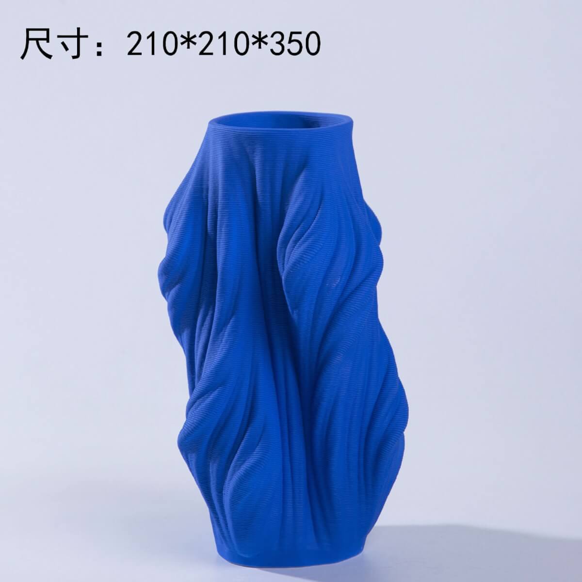 Blue 3D printed ceramic vase with unique textured design on a light background.