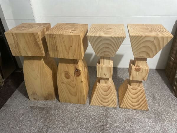 Set of 4 natural solid wood kitchen stools with visible wood grain and knots.