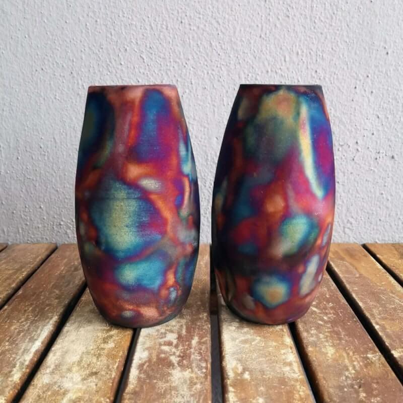 Two vibrant, multicolored raku pottery vases.  Smoked raku finish with a mix of blues, reds, and oranges.  Perfect for home decor.
