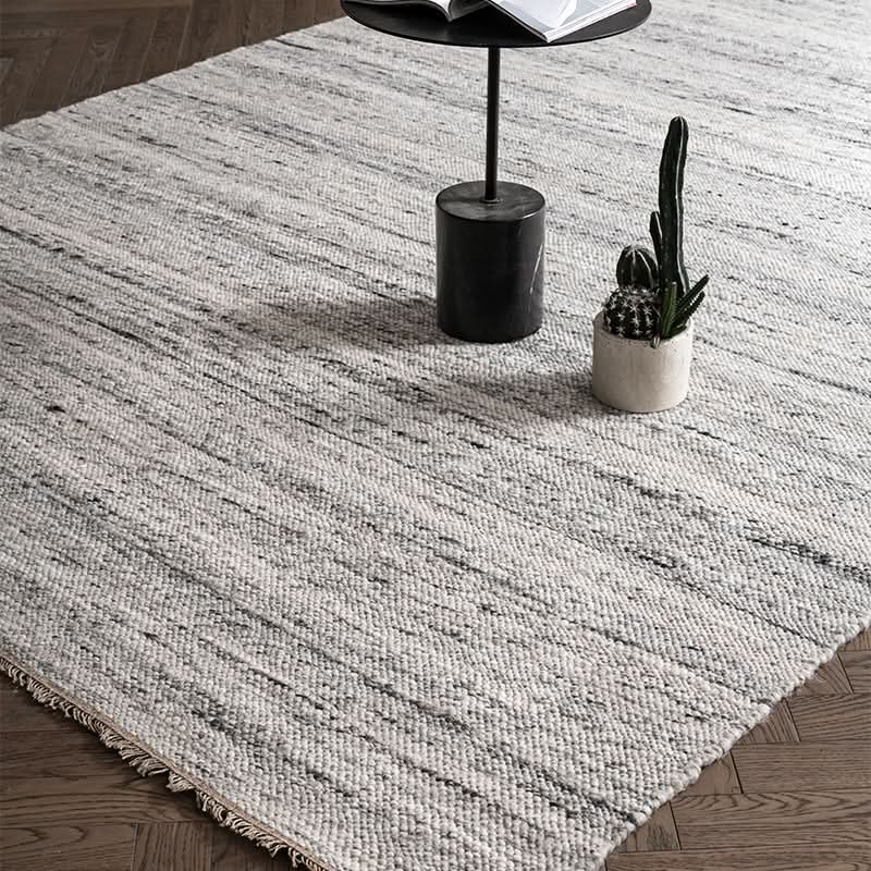 Textured Natural Wool Carpet in a modern living room setting with a side table and potted cactus.