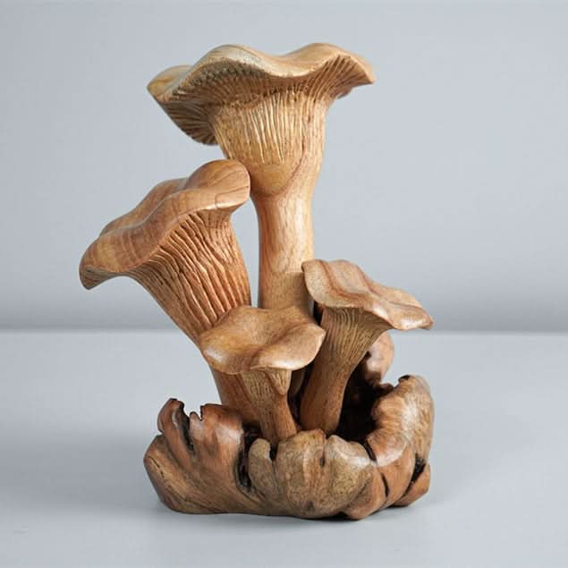 Hand-carved wood mushroom sculpture, a natural home decor piece.