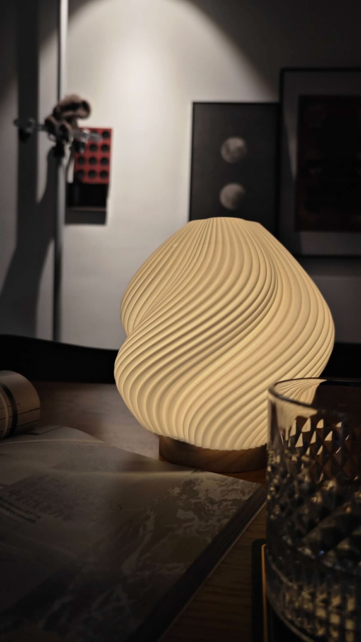 Whimsical Wave Table Lamp: modern cream textured shade, warm glow on wooden table with book & glass.