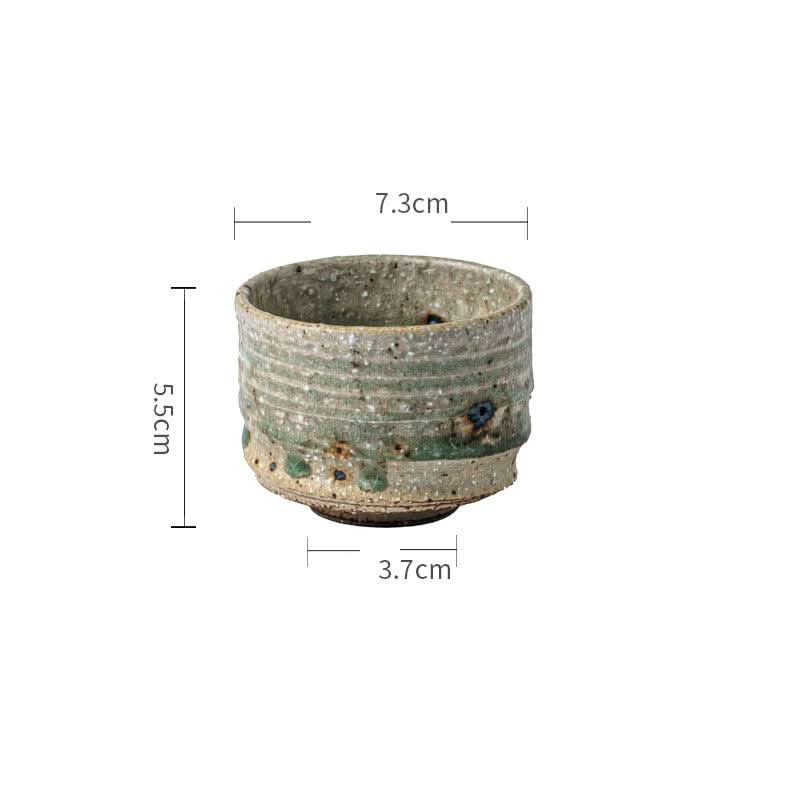 Artisan Green Dinnerware ceramic cup, textured green and beige glaze, with dimensions 5.5cm H x 7.3cm W.