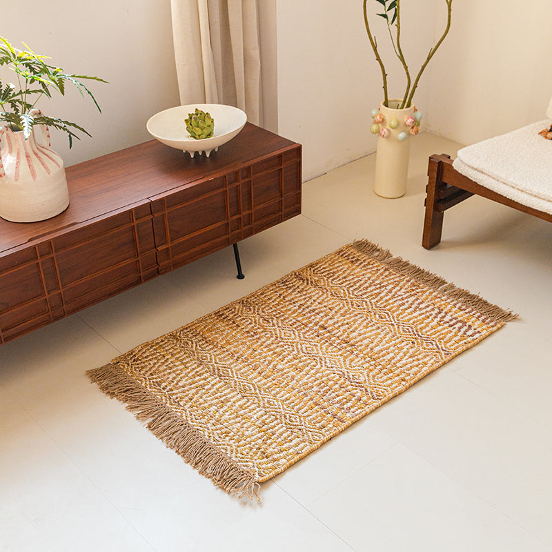 Beige rug with diamond pattern and fringe.