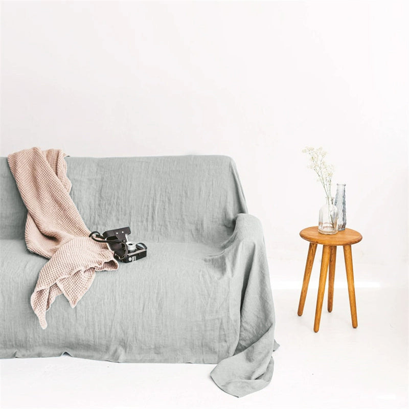 Mustard Yellow Linen Sofa Throw Blanket on gray couch with pink blanket & camera. Cozy decor.