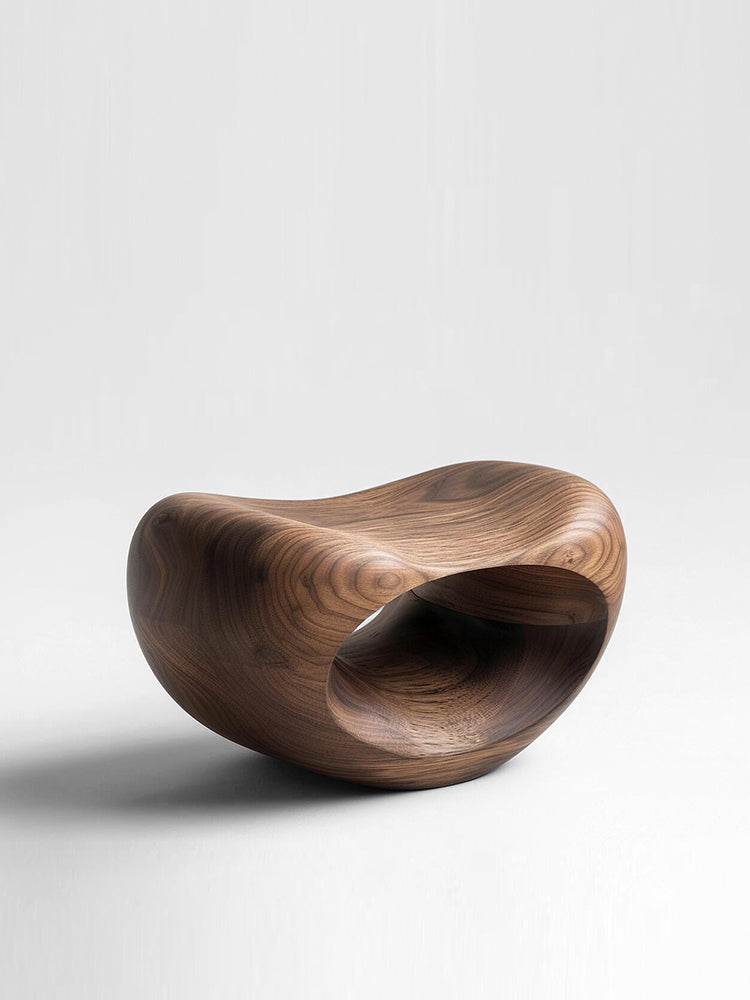 Hand-carved walnut wood pumpkin stool with organic, flowing form on white background.