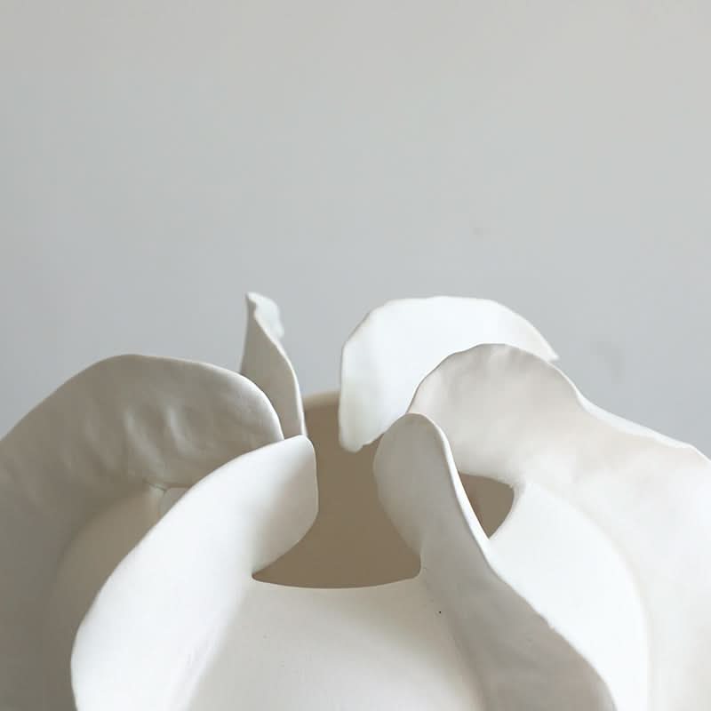 Close-up of modern white ruffled ceramic vase set, home decor