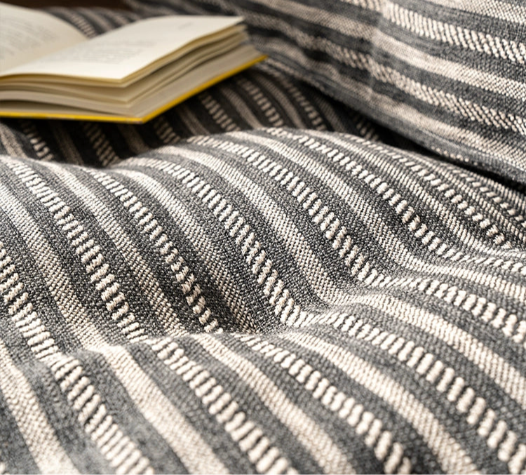 Modern Minimalist Floor Sofa with striped fabric and a yellow-covered book