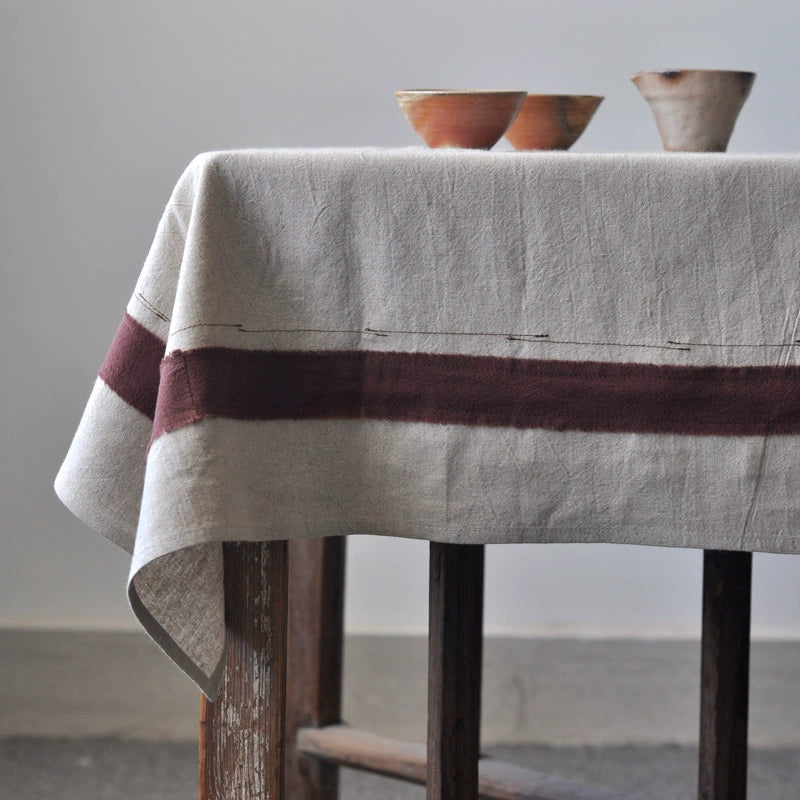 Rustic Linen Tablecloth with Striped Border, neutral tones, maroon stripe, natural texture.