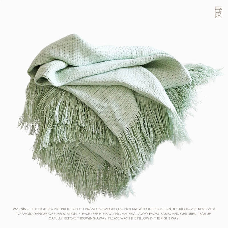 Sage green linen throw blanket with fringe. Cozy home decor accent.