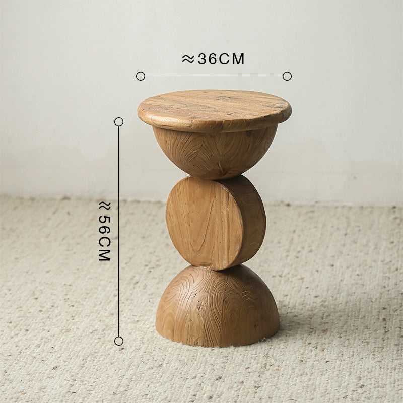 Bohemian wooden side table, stacked round design, natural wood finish on textured rug