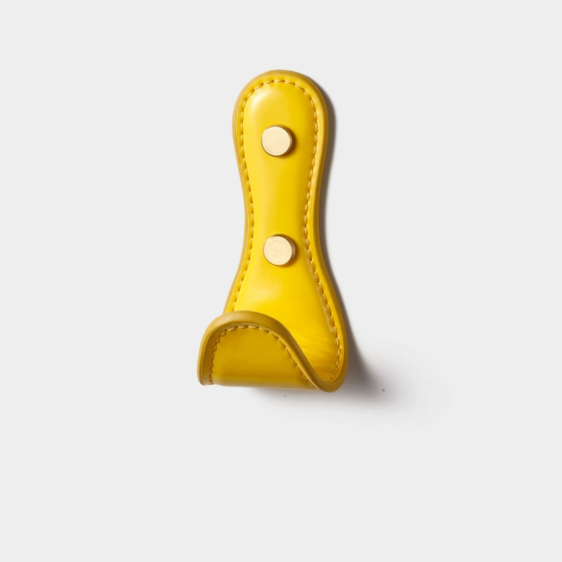 Yellow leather wall hook with gold accents. Colorful leather wall hooks for dopamine decor.
