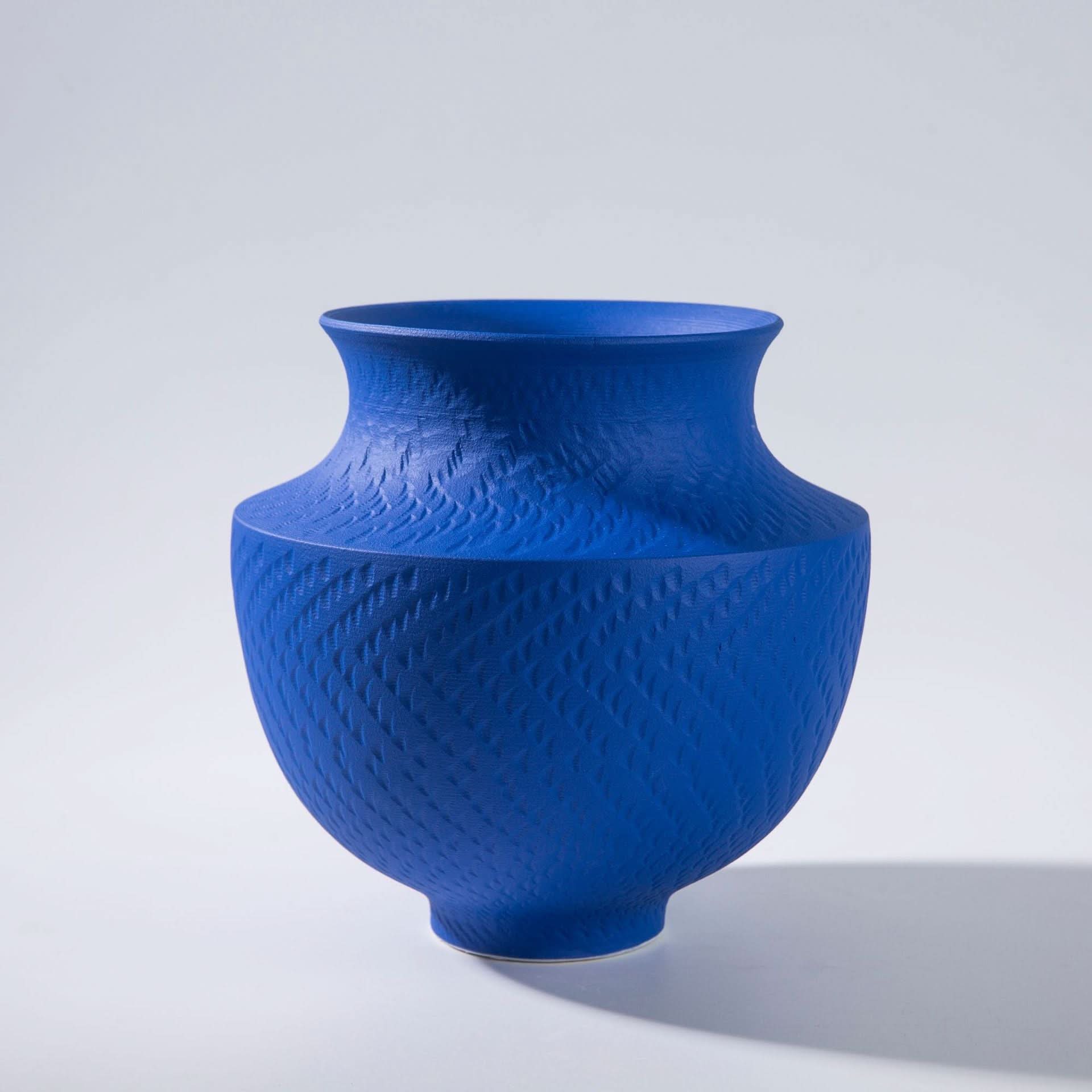 Vibrant blue textured vase with a matte finish, home decor object.