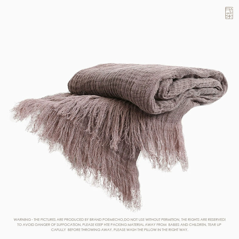 Dusty rose linen throw blanket with textured weave and delicate fringes.  Rustic style.