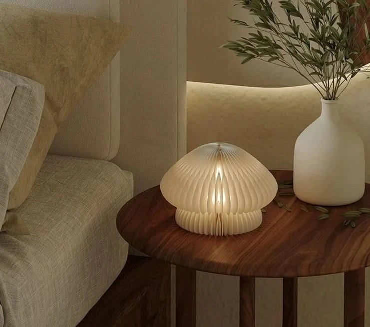 Paper Origami Mushroom Bedside Lamp on wooden table, soft glow, cozy bedroom decor.