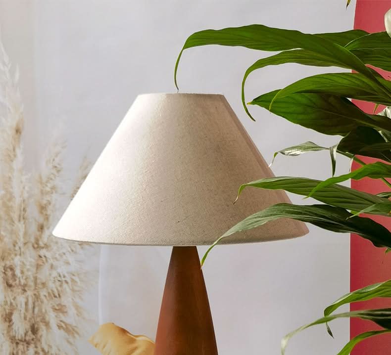 Wood Mid Century Table Lamp with tan linen shade and terracotta base, styled with greenery.